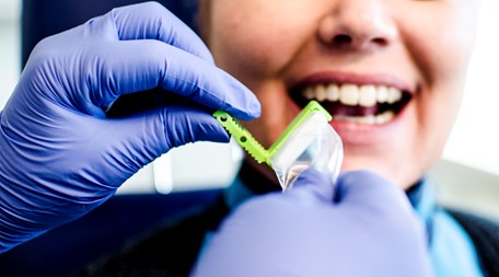En patient får en röntgenfilm insatt i munnen.