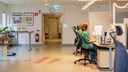 Två vårdadministratörer sitter vid skrivbord och arbetar.